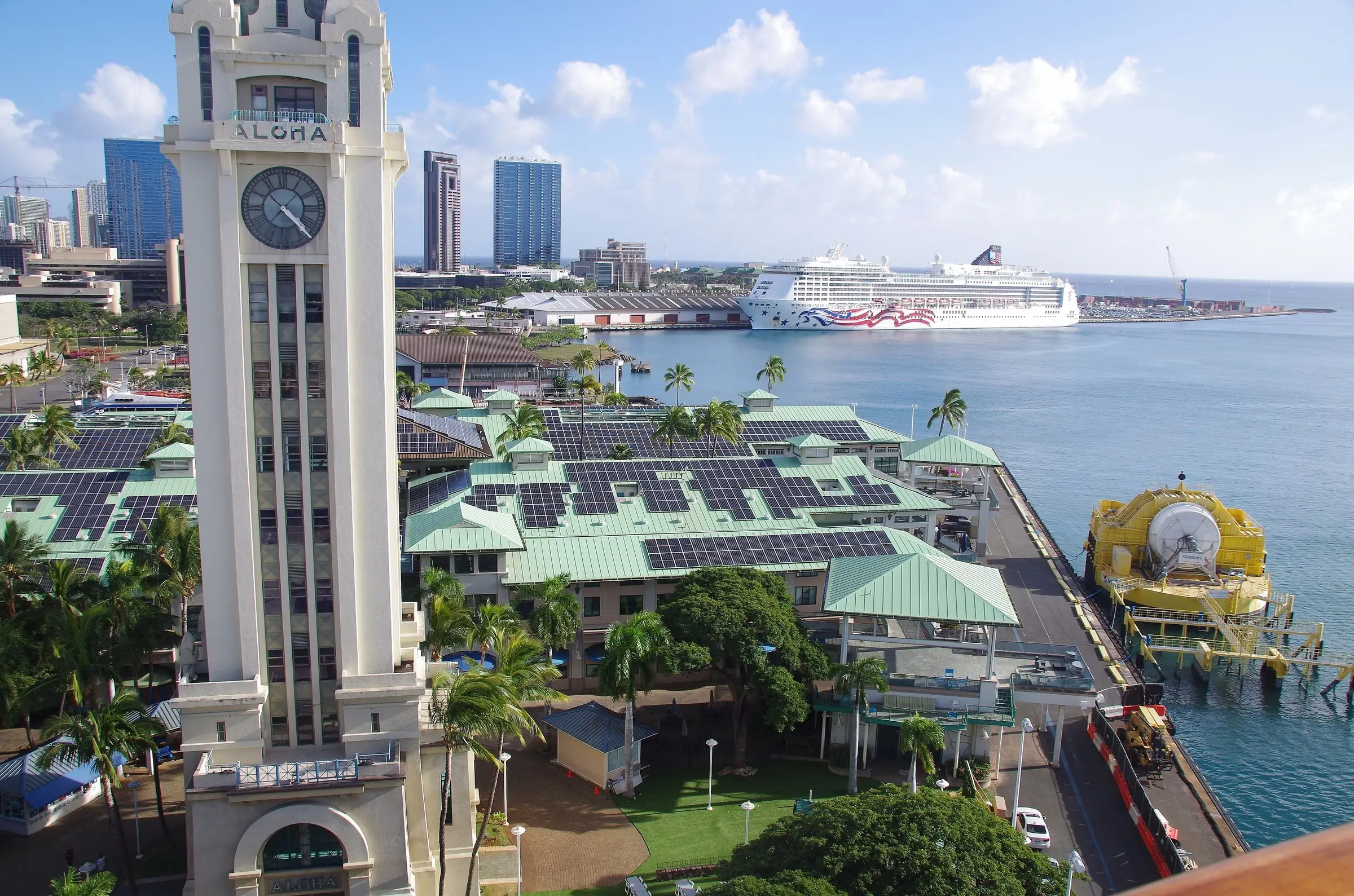 Aloha Tower and the cruise pier in Honolulu harbor, with a cruise ship docked